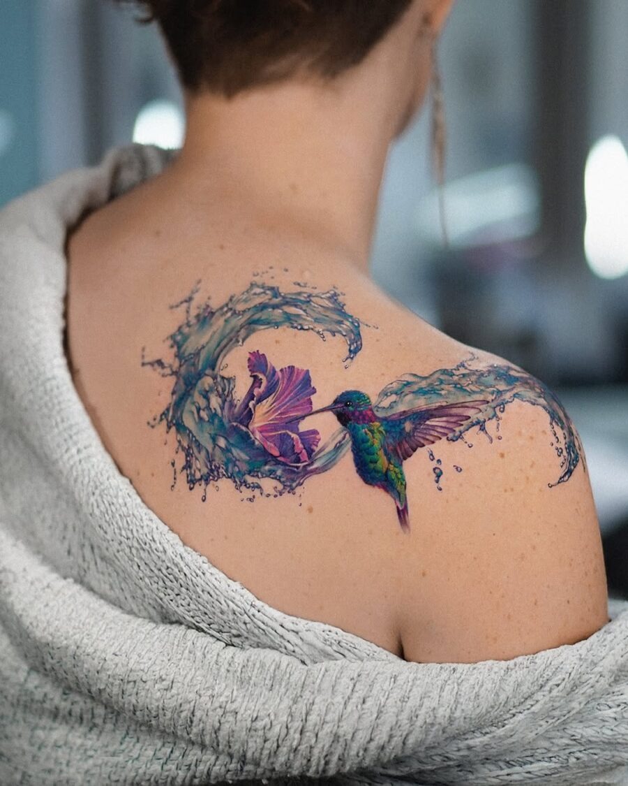 A vibrant hummingbird tattoo with floral elements Tattoo Design