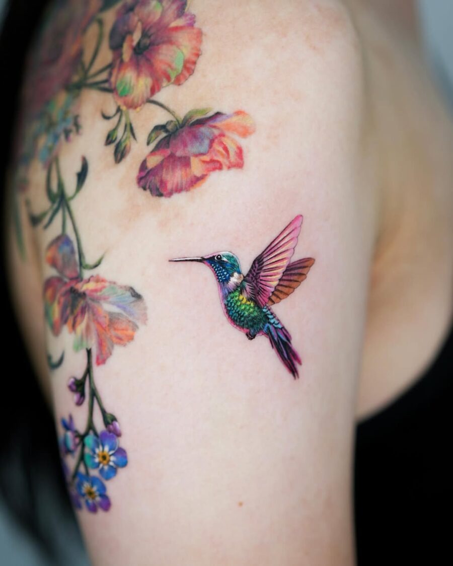 Colorful hummingbird tattoo with floral accent Tattoo Design