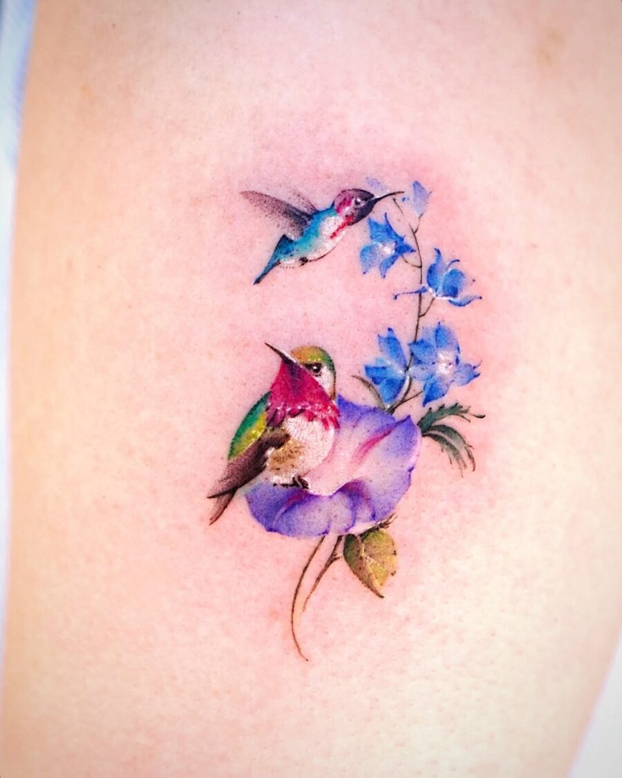 Colorful hummingbird tattoo with vibrant floral elements Tattoo Design