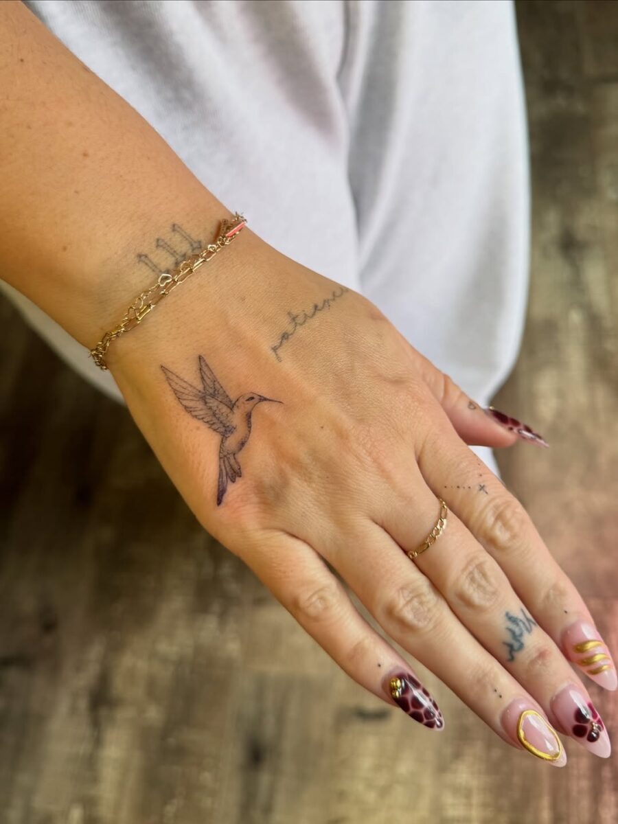 Delicate Hummingbird Tattoo on Hand Tattoo Design