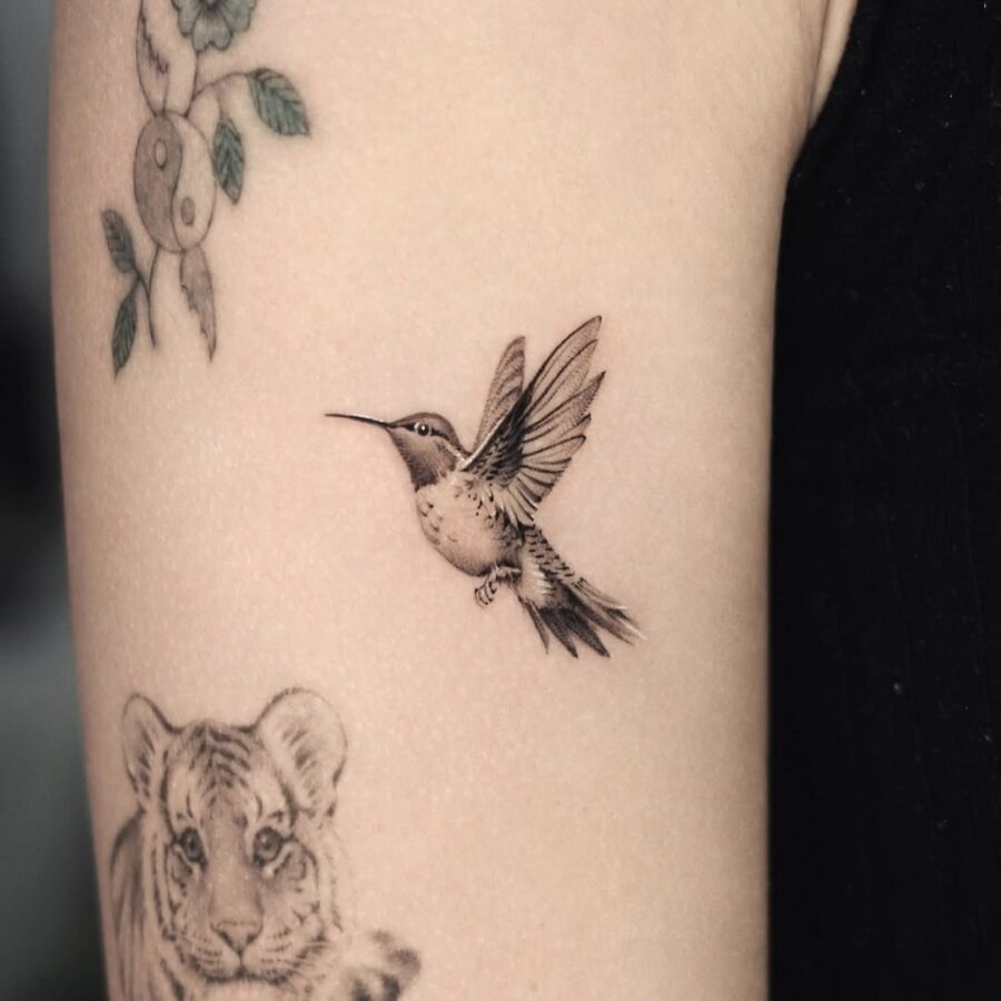 Delicate hummingbird tattoo with intricate details Tattoo Design