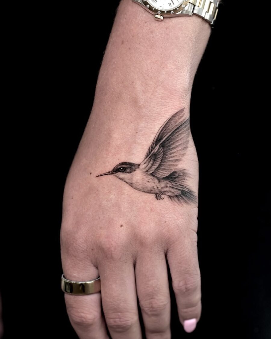 Elegant hummingbird tattoo in dynamic flight Tattoo Design