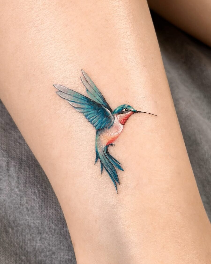 Elegant hummingbird tattoo in vibrant colors Tattoo Design