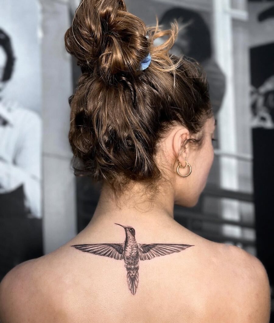 Elegant hummingbird tattoo on the back Tattoo Design