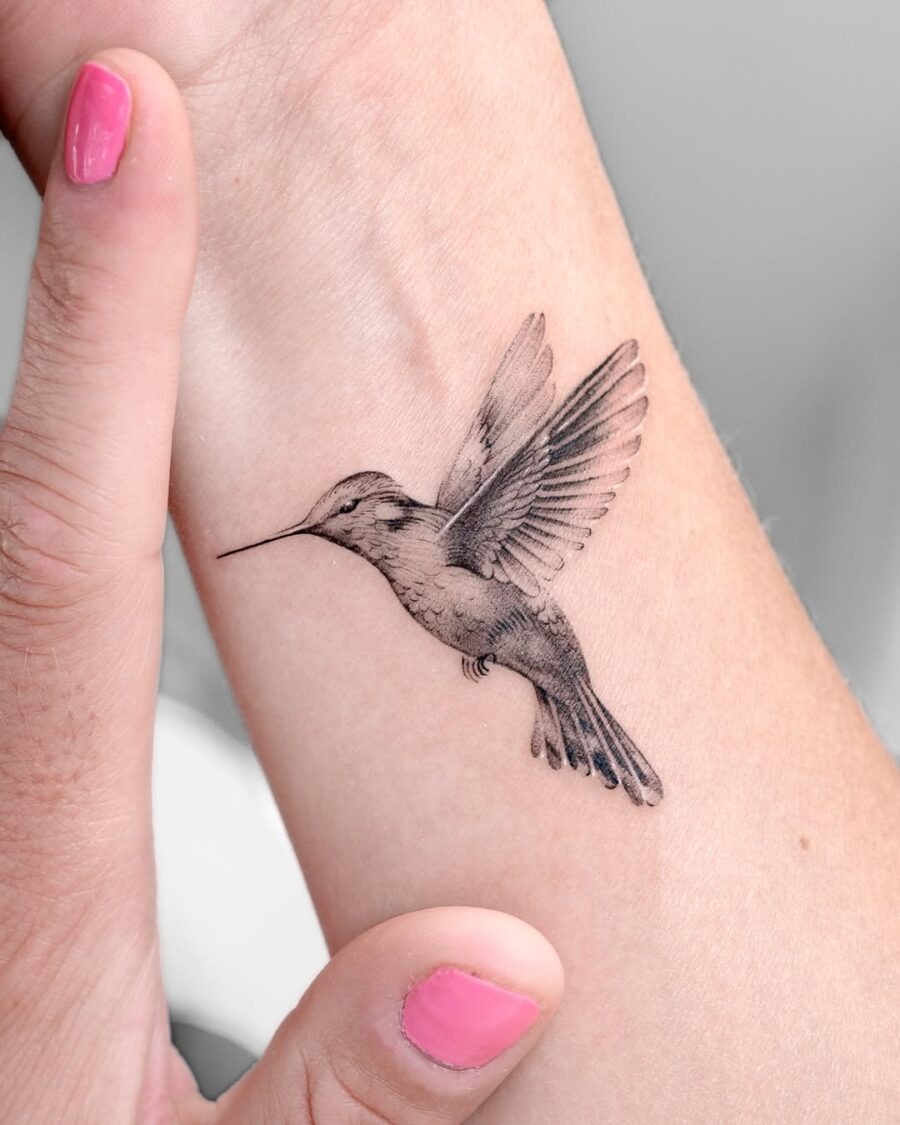 Realistic hummingbird tattoo design on arm Tattoo Design