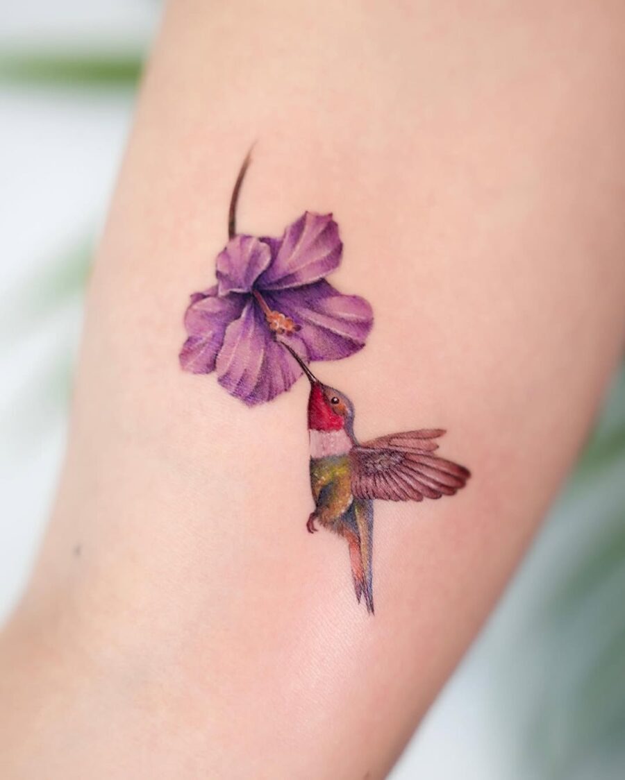 Vibrant Hummingbird Sipping Nectar from Bloom Tattoo Design