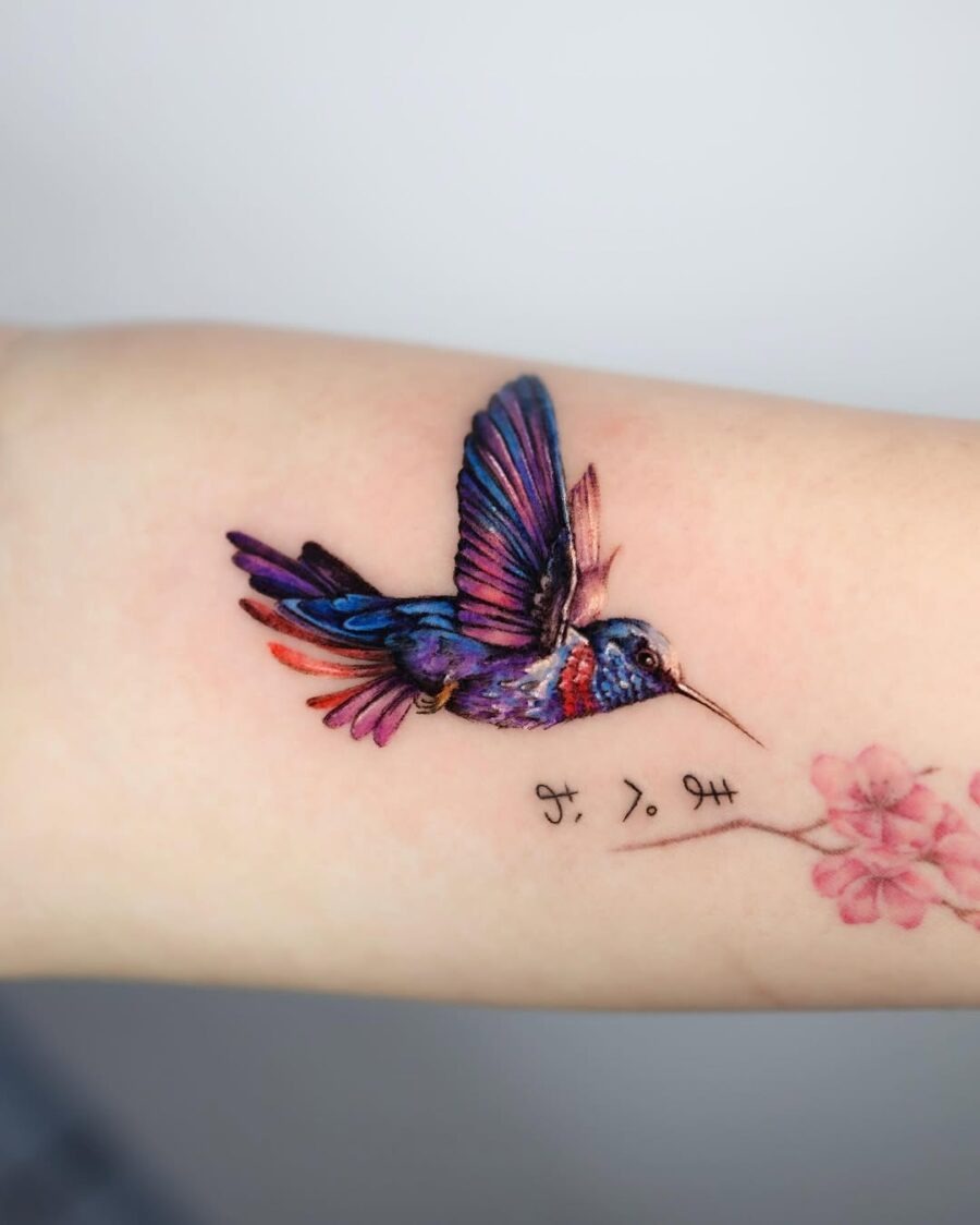 Vibrant hummingbird soaring with floral accents Tattoo Design