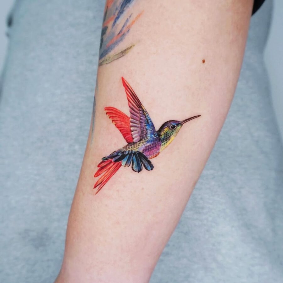 Vibrant hummingbird tattoo on forearm Tattoo Design