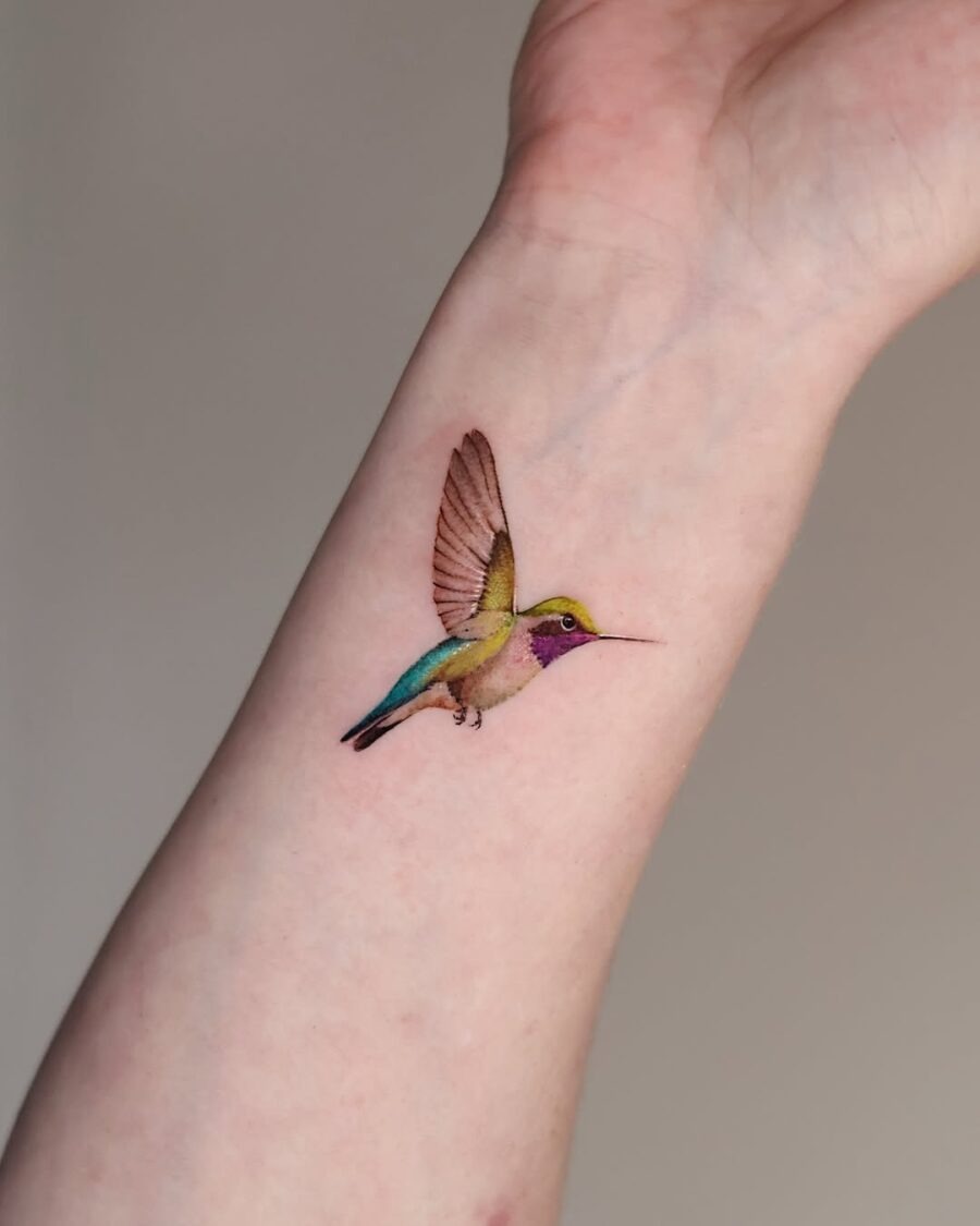Vibrant hummingbird tattoo on the arm Tattoo Design