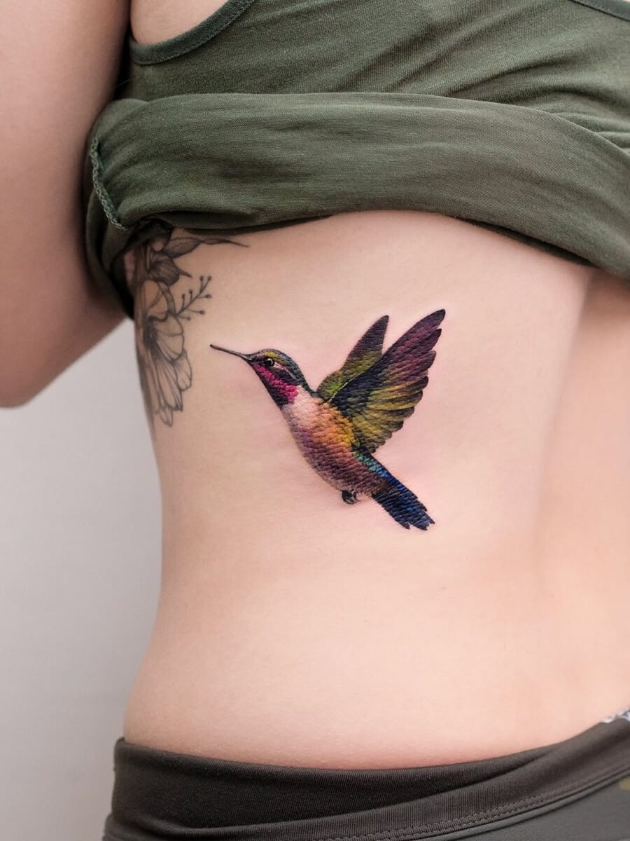 Vibrant hummingbird tattoo on the side Tattoo Design