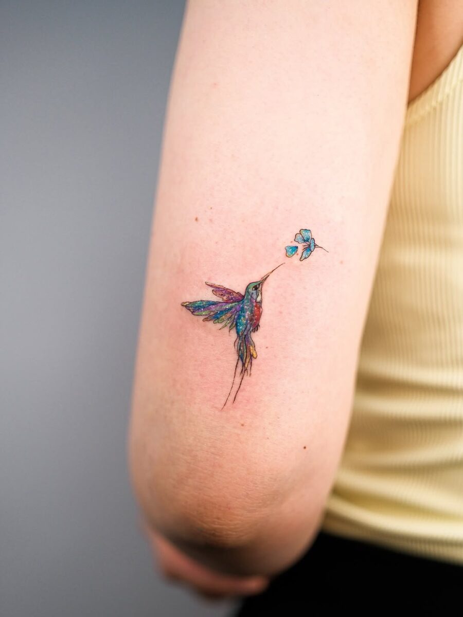Vibrant hummingbird tattoo sipping from flower Tattoo Design