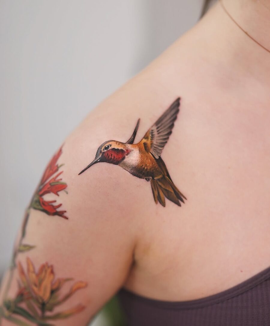 Vibrant hummingbird tattoo with floral accents Tattoo Design