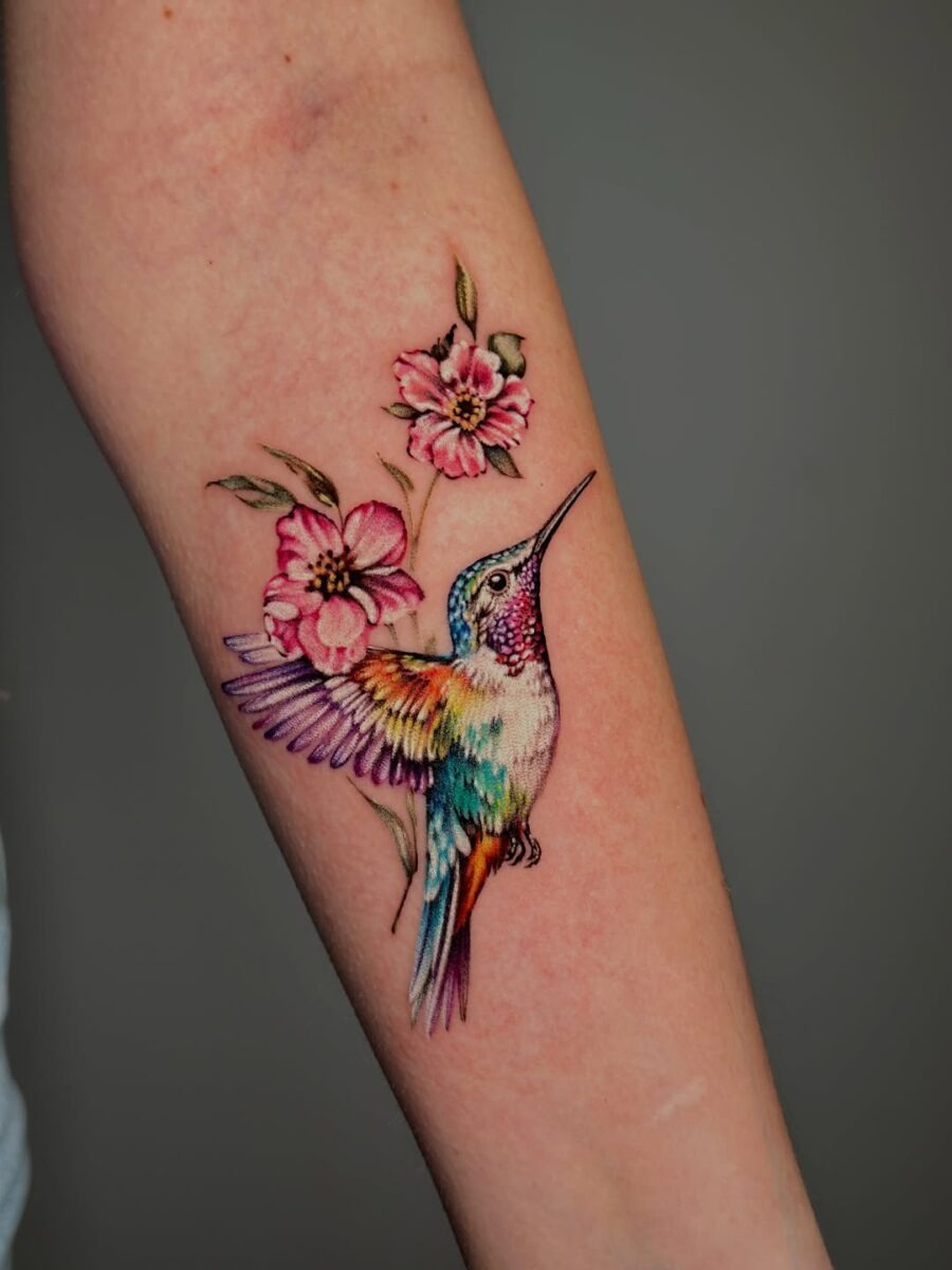 Vibrant hummingbird tattoo with floral accents Tattoo Design
