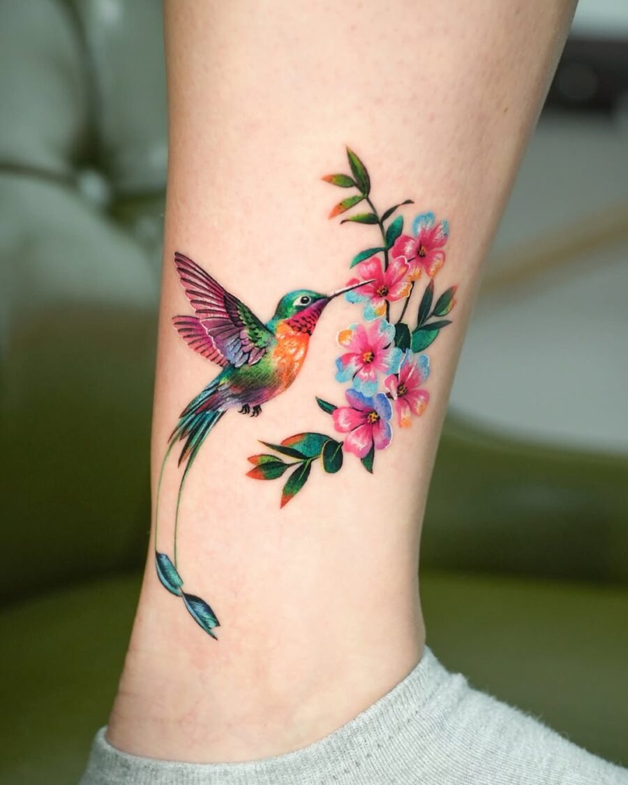 Vibrant hummingbird tattoo with floral accents Tattoo Design