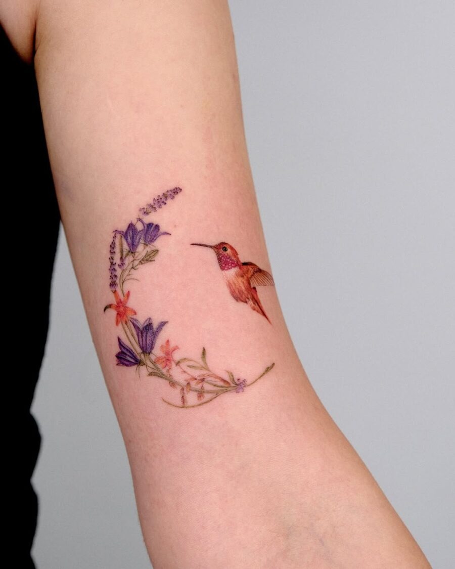 Vibrant hummingbird tattoo with floral accents Tattoo Design