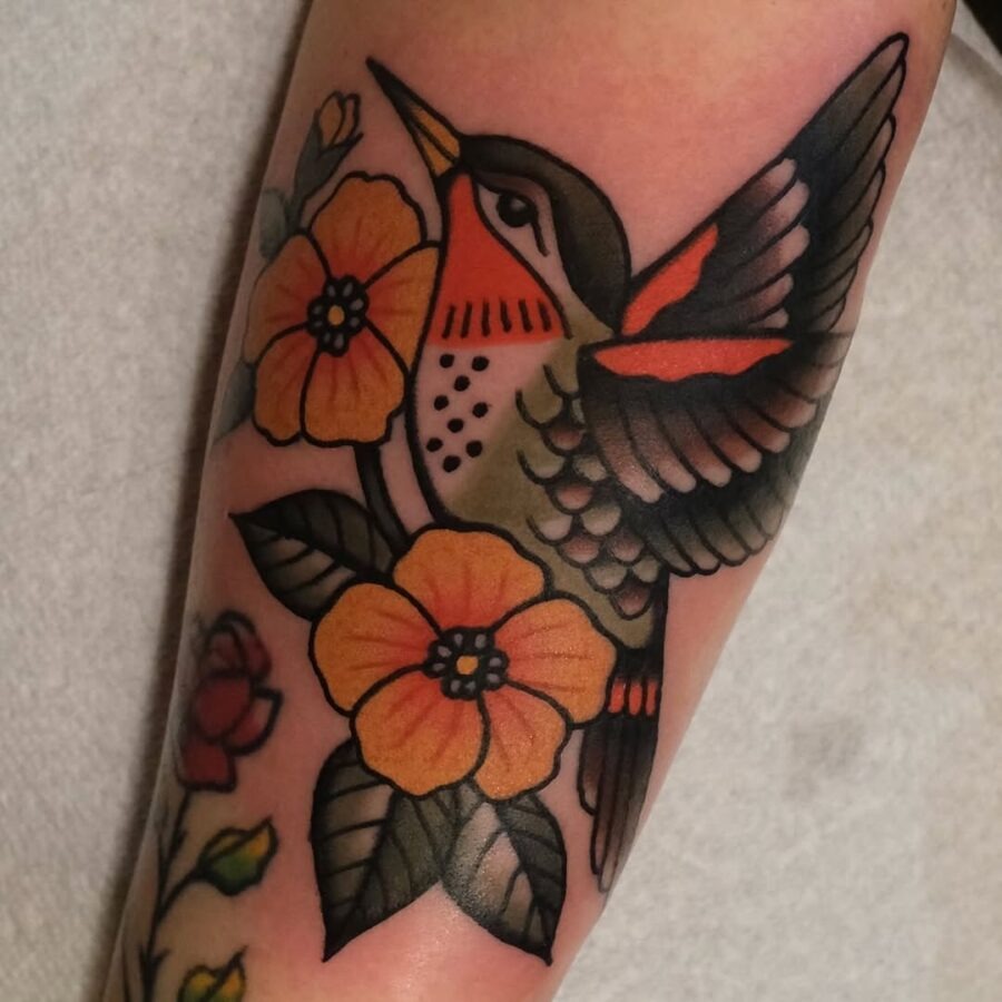 Vibrant hummingbird tattoo with floral elements Tattoo Design