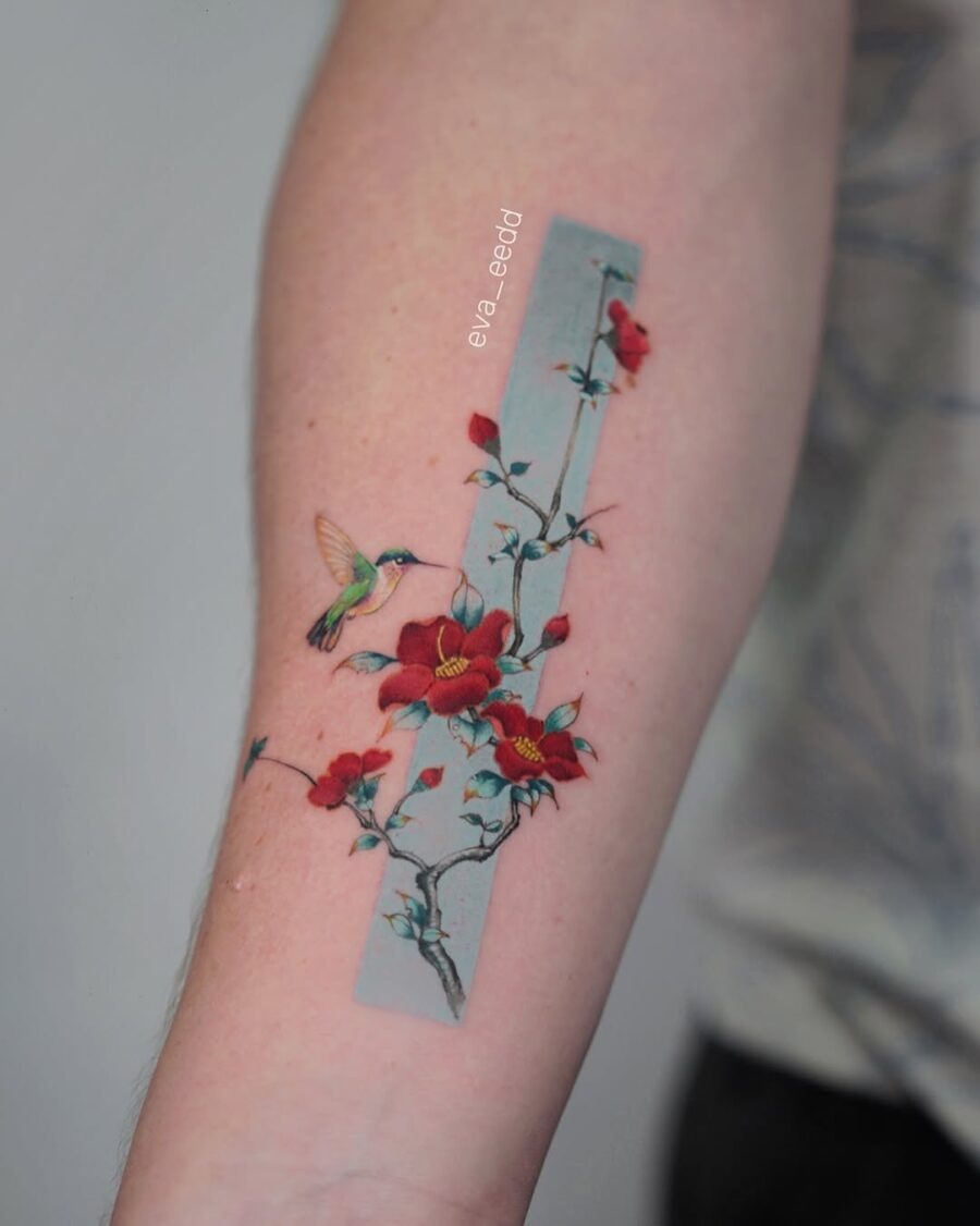 Vibrant hummingbird with blossoming flowers tattoo Tattoo Design