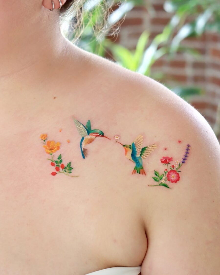 Vivid hummingbird tattoo with floral embellishments Tattoo Design