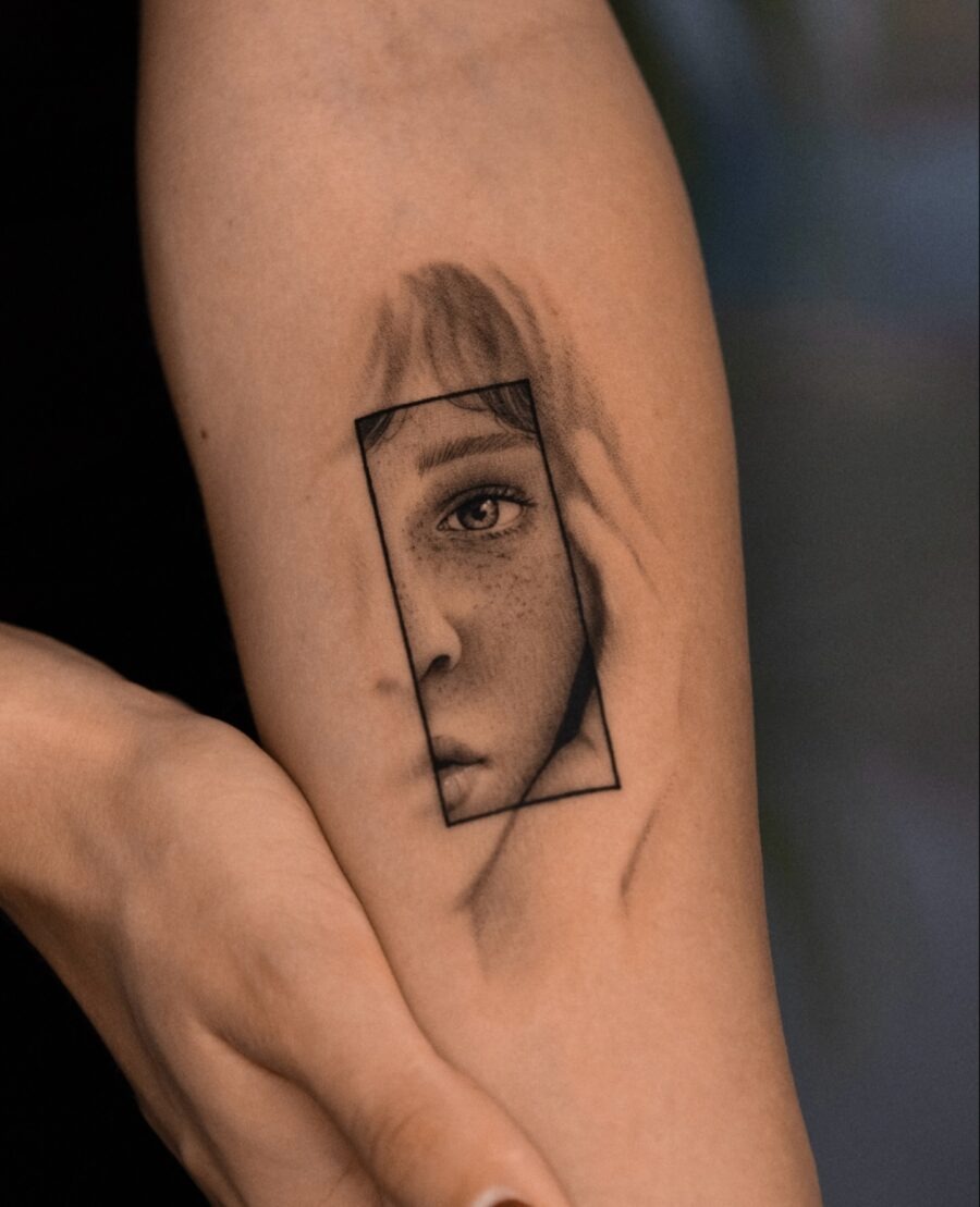 Intricate Tattoo of a Framed Face Tattoo Design