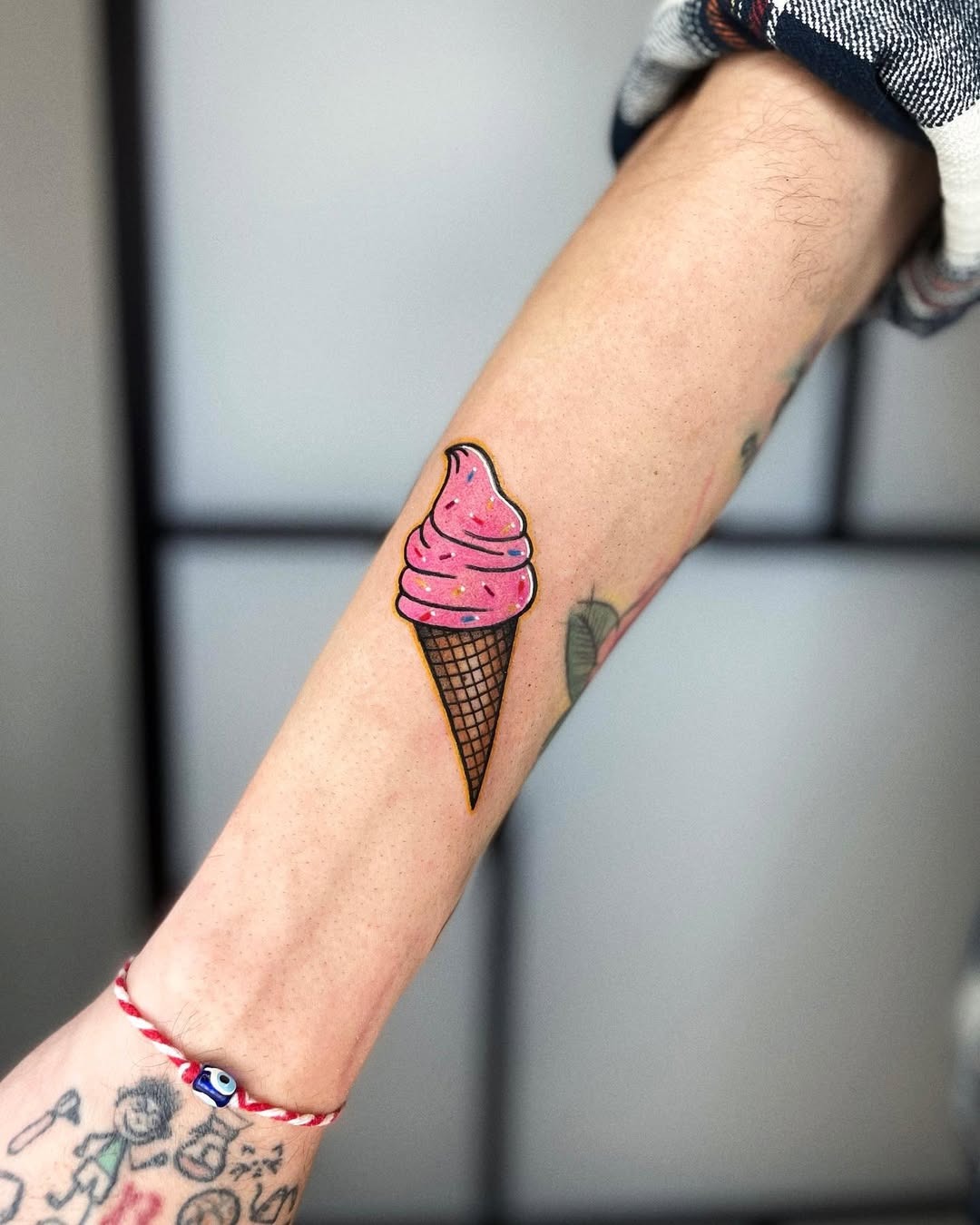 Charming ice cream cone tattoo on forearm Tattoo Design