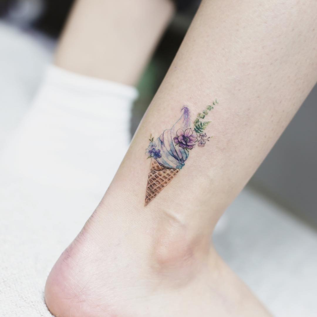 Charming ice cream cone tattoo with floral accents Tattoo Design