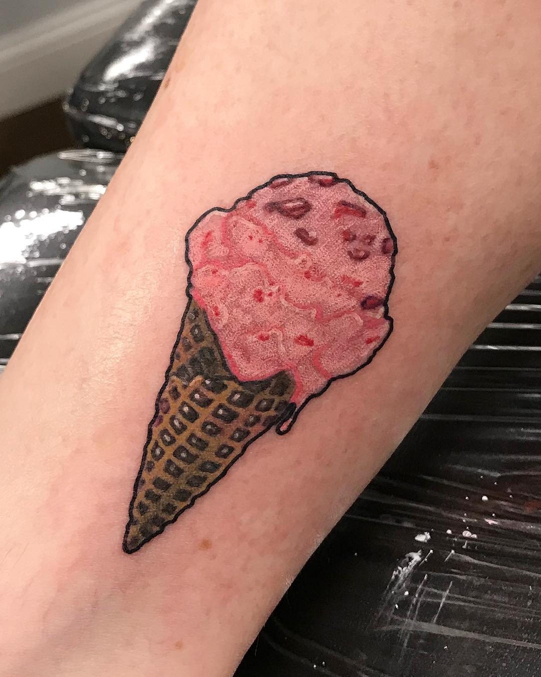 Charming pink ice cream cone tattoo on skin Tattoo Design