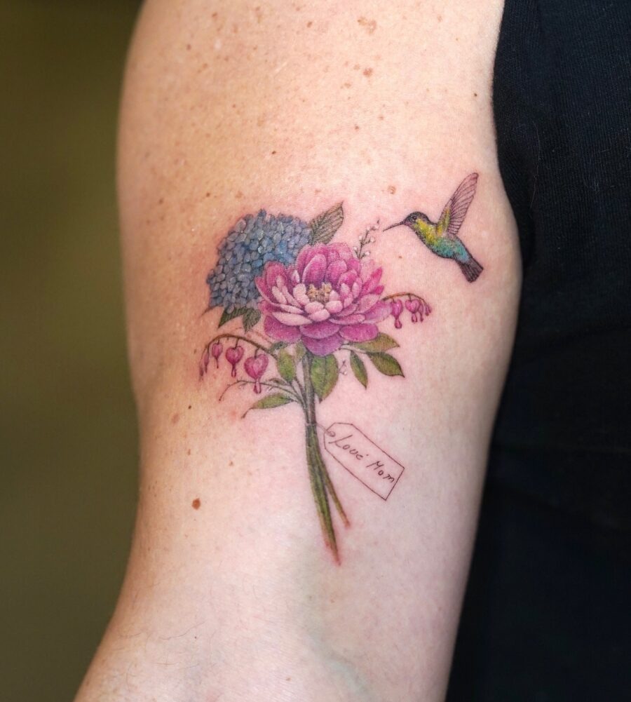 A vibrant tribute with flowers and a hummingbird Tattoo Design