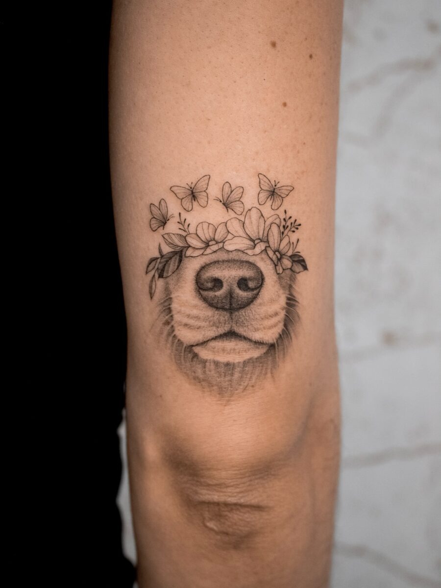 Beautiful dog tattoo with floral and butterfly accents Tattoo Design