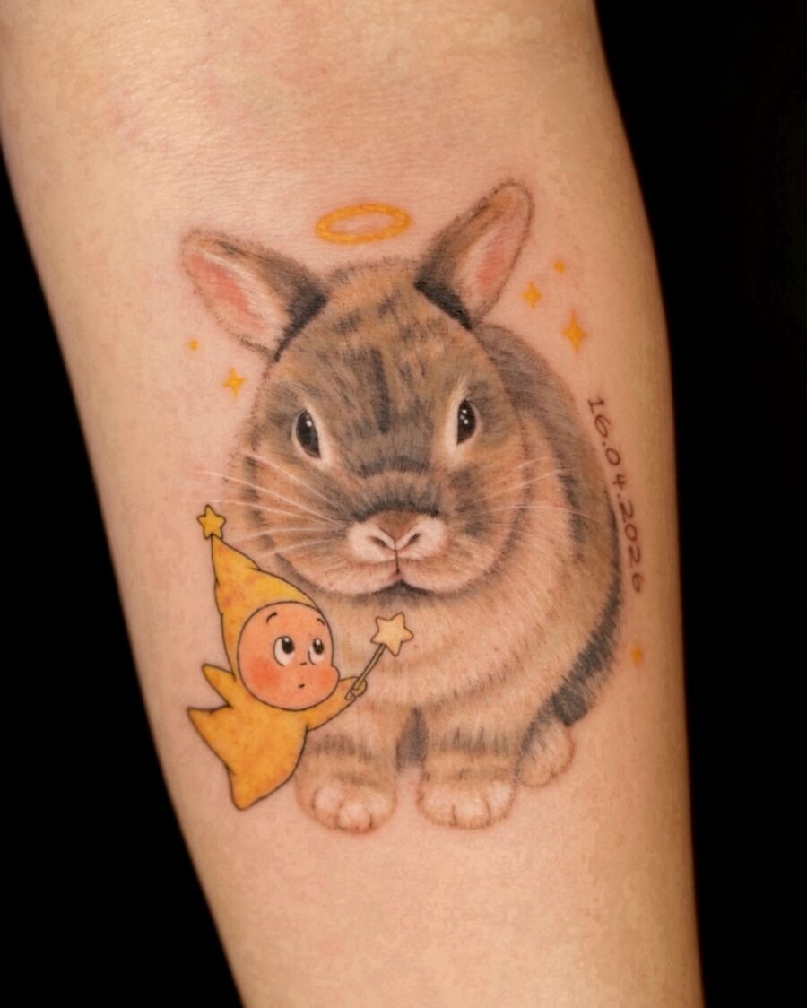 Charming rabbit memorial tattoo with angelic touch Tattoo Design