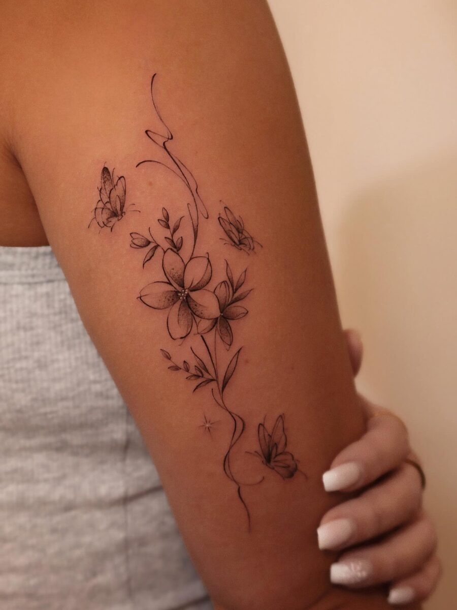 Delicate floral tribute engraved on skin Tattoo Design