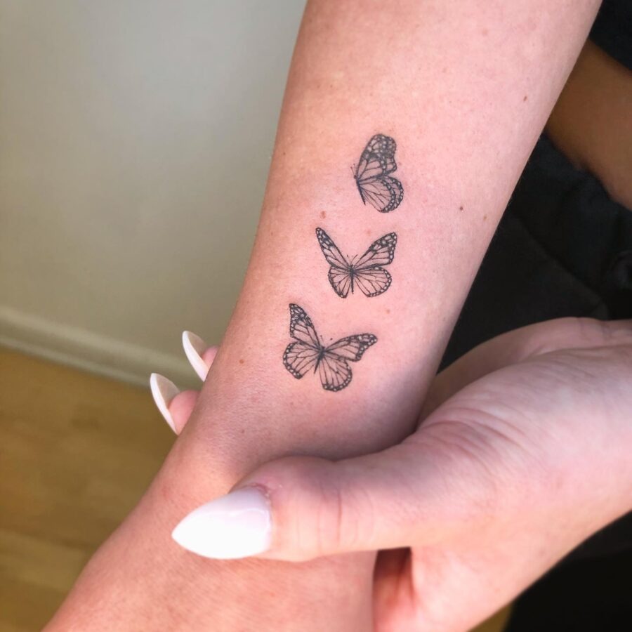 Elegant butterflies representing cherished memories. Tattoo Design