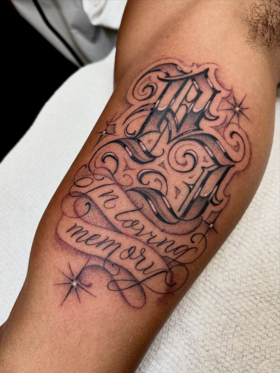 Elegant script tattoo honoring cherished memories Tattoo Design