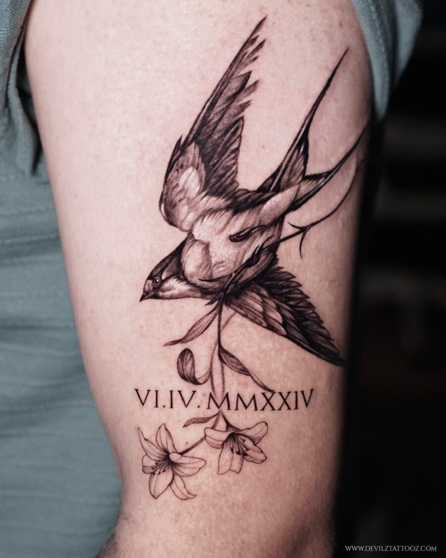 Elegant tribute tattoo featuring a swallow and flowers Tattoo Design