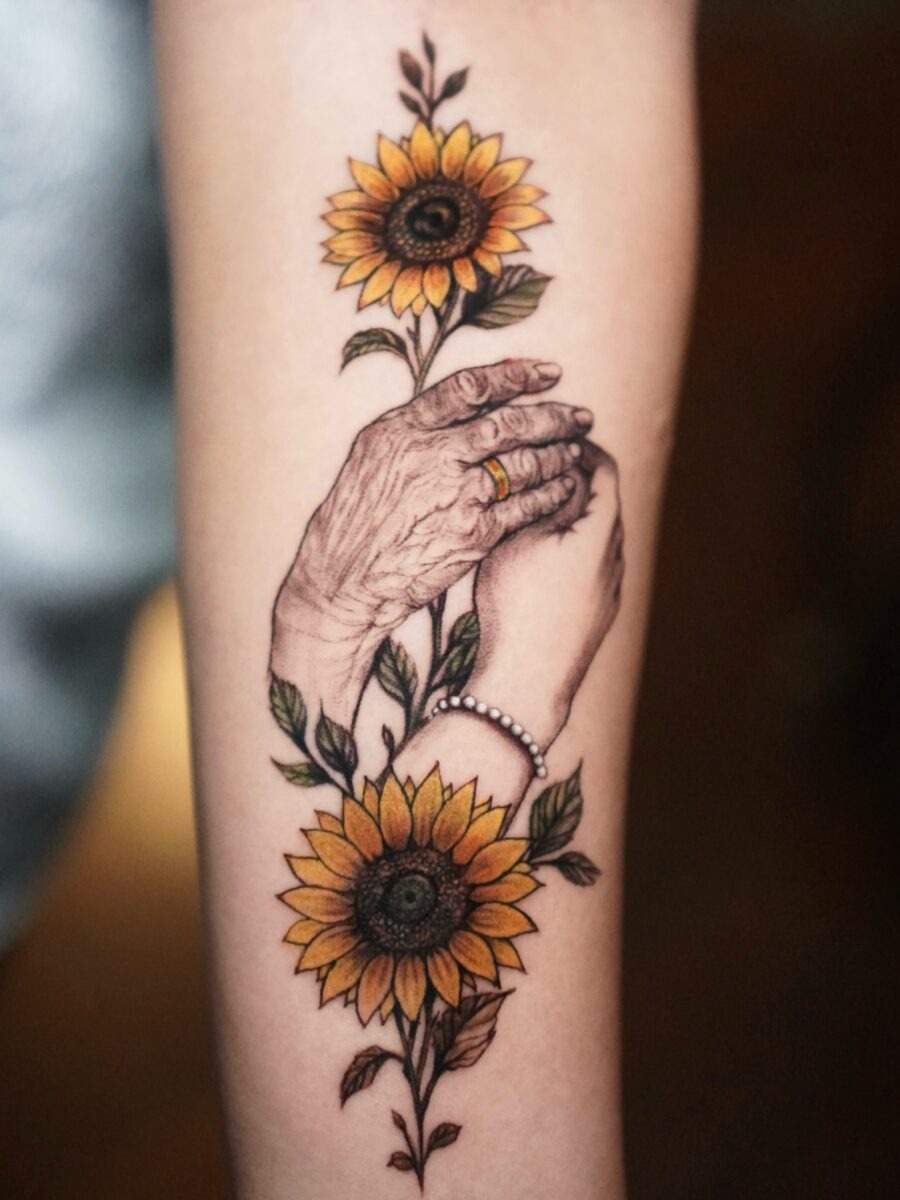 Symbolic hands and sunflowers in memory Tattoo Design