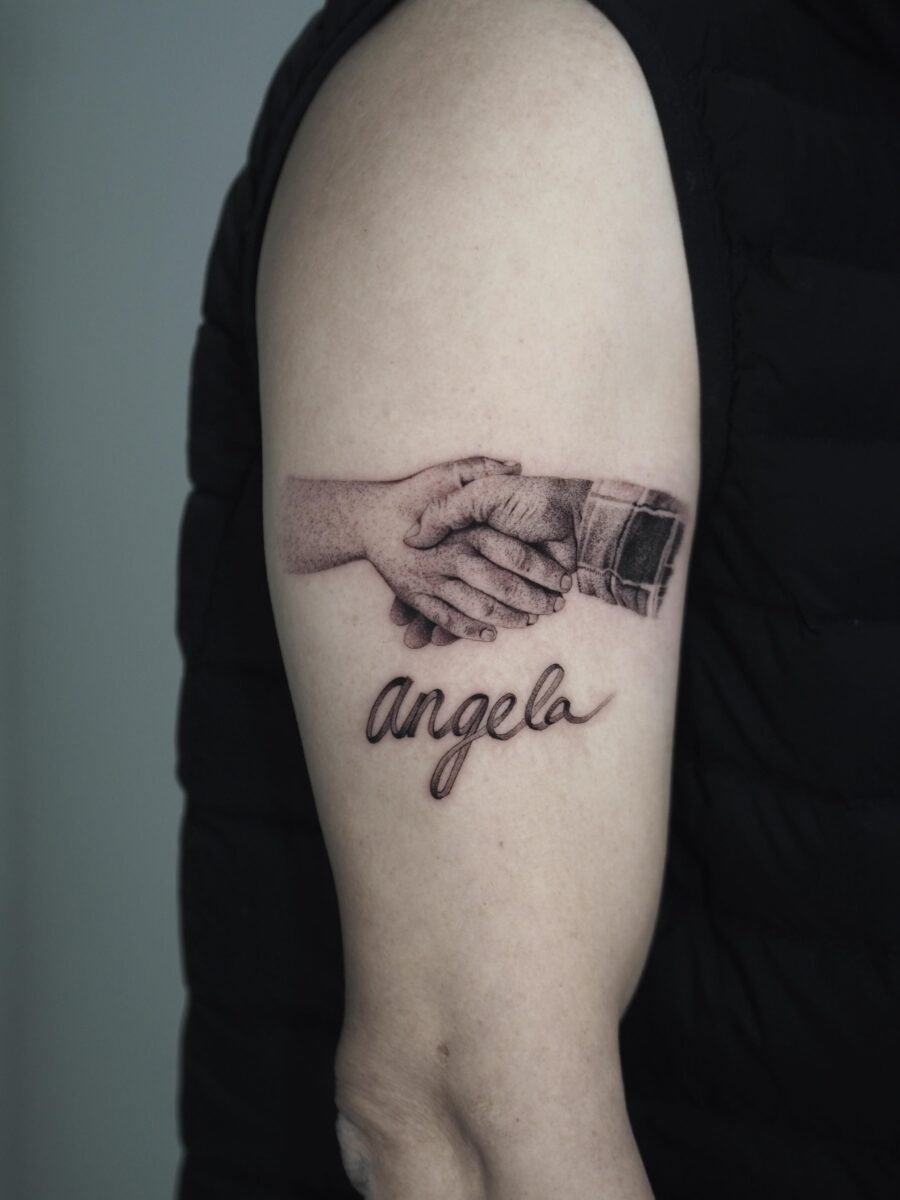 Touching tribute through hands and name tattoo Tattoo Design