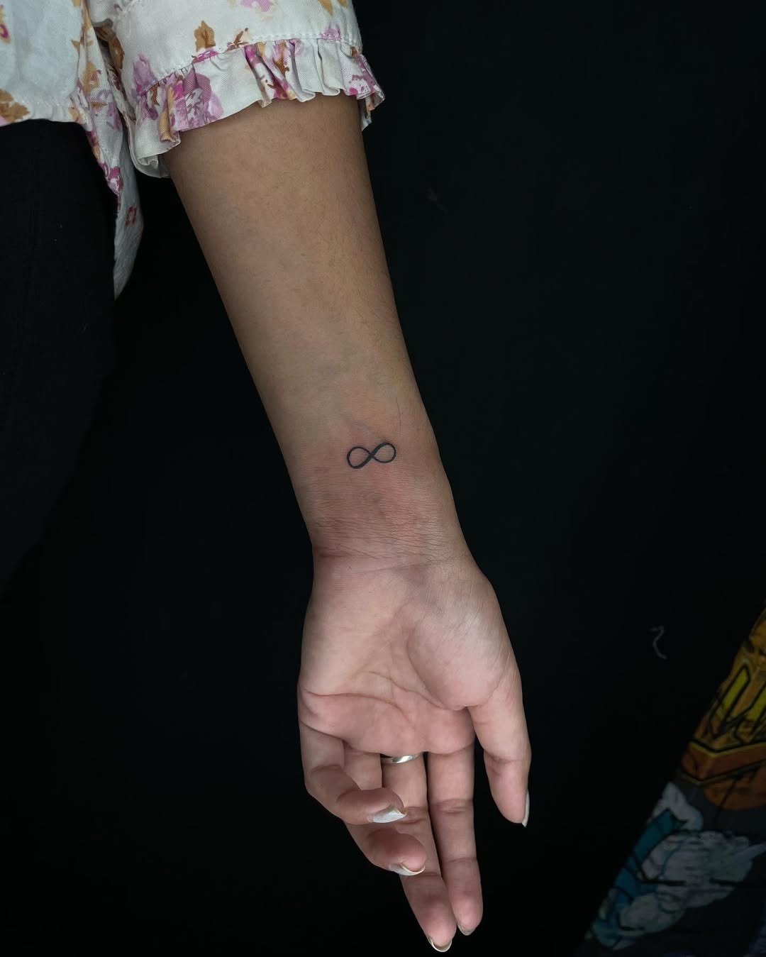 A graceful infinity symbol intertwined with a rose Tattoo Design