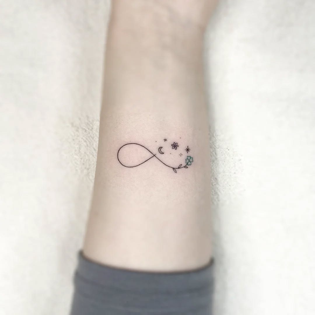 Delicate infinity floral tattoo on the back Tattoo Design