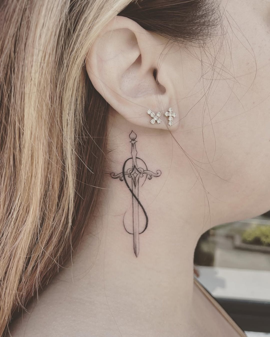 Elegant infinity sword tattoo on the neck Tattoo Design