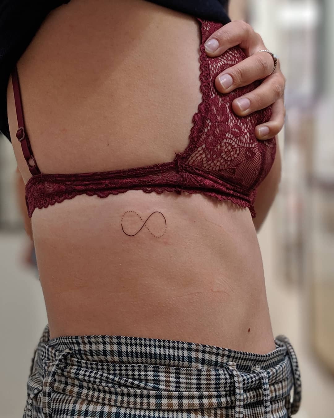 Elegant infinity tattoo with floral details Tattoo Design