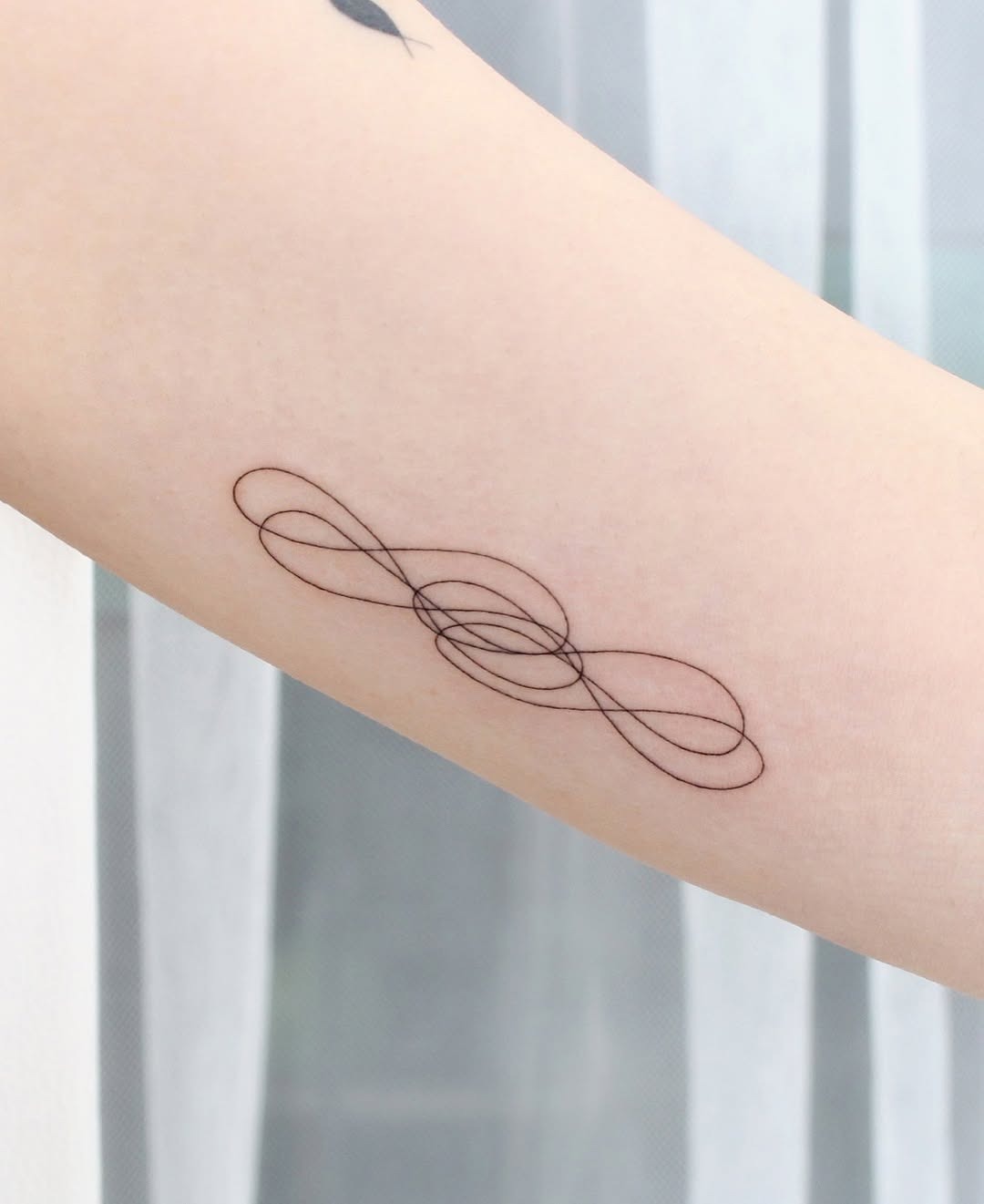 Elegant infinity tattoo with unique line art Tattoo Design