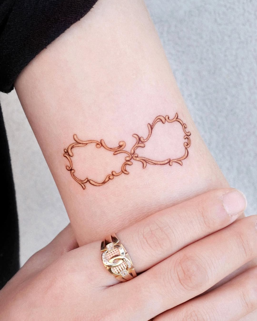 Intricate infinity tattoo with floral elements Tattoo Design