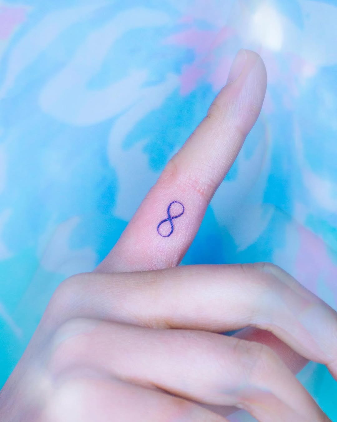 Minimalist infinity tattoo on a finger Tattoo Design