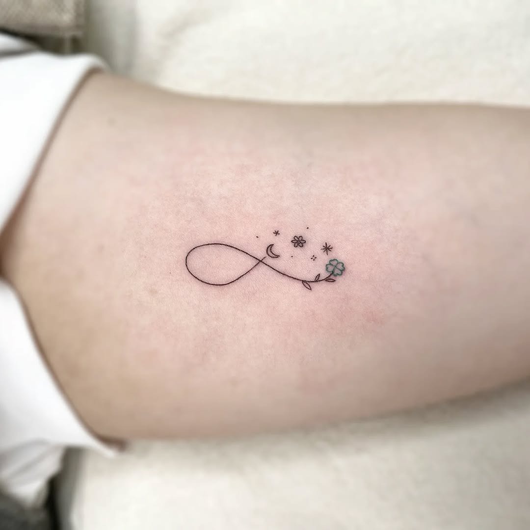 Minimalist infinity tattoo with floral elements Tattoo Design