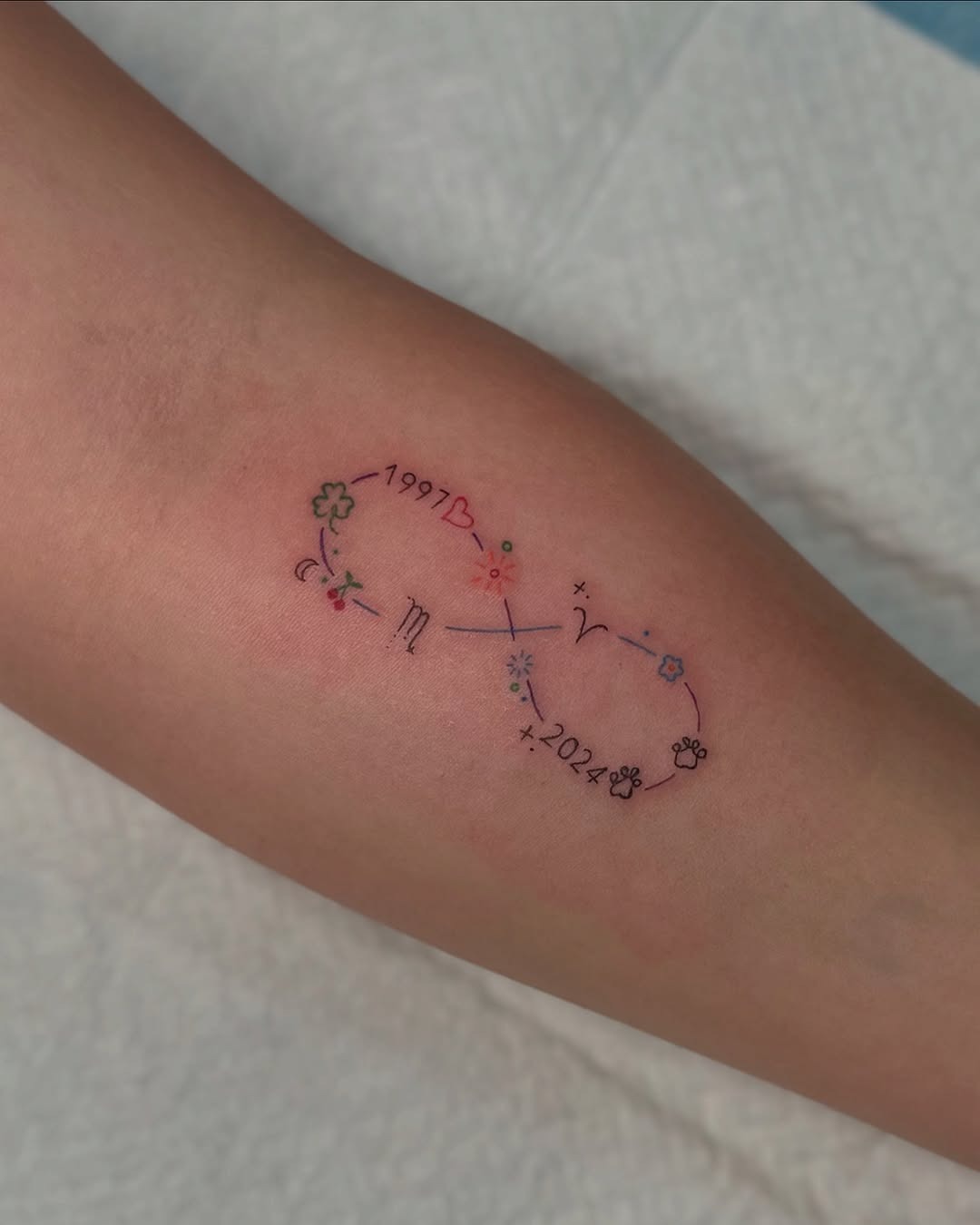 Whimsical infinity tattoo with celestial elements Tattoo Design