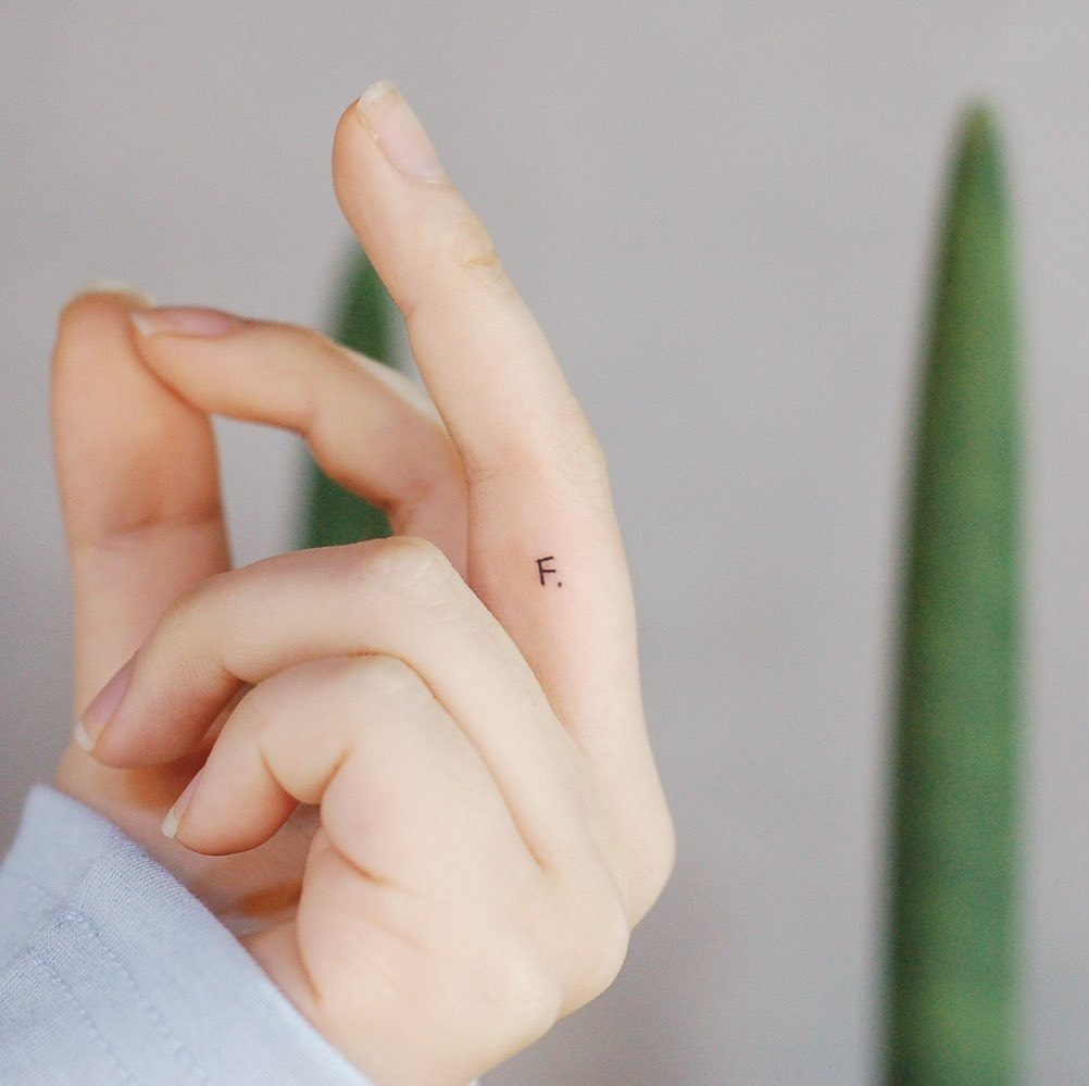 Chic Minimalist Initials Tattoo on Finger Tattoo Design