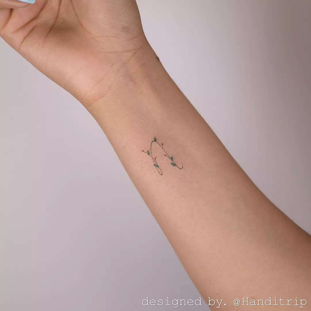 Elegant Initials Tattoo with Floral Accents Tattoo Design