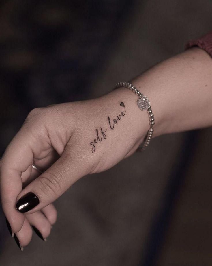Self Love, a tattoo design rendered in clean detailed linework for the hand.