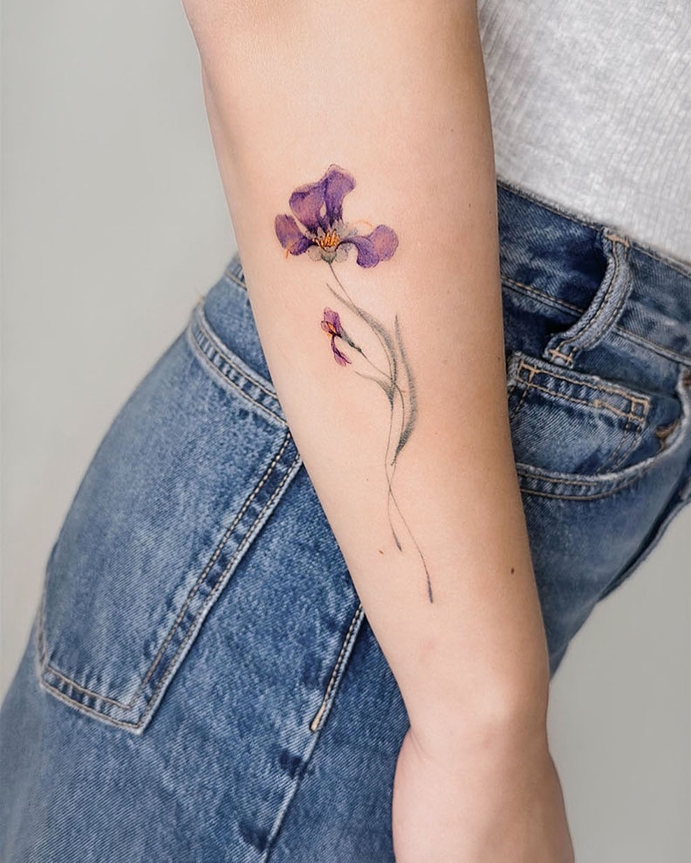 This iris tattoo features a beautifully detailed, flower design.