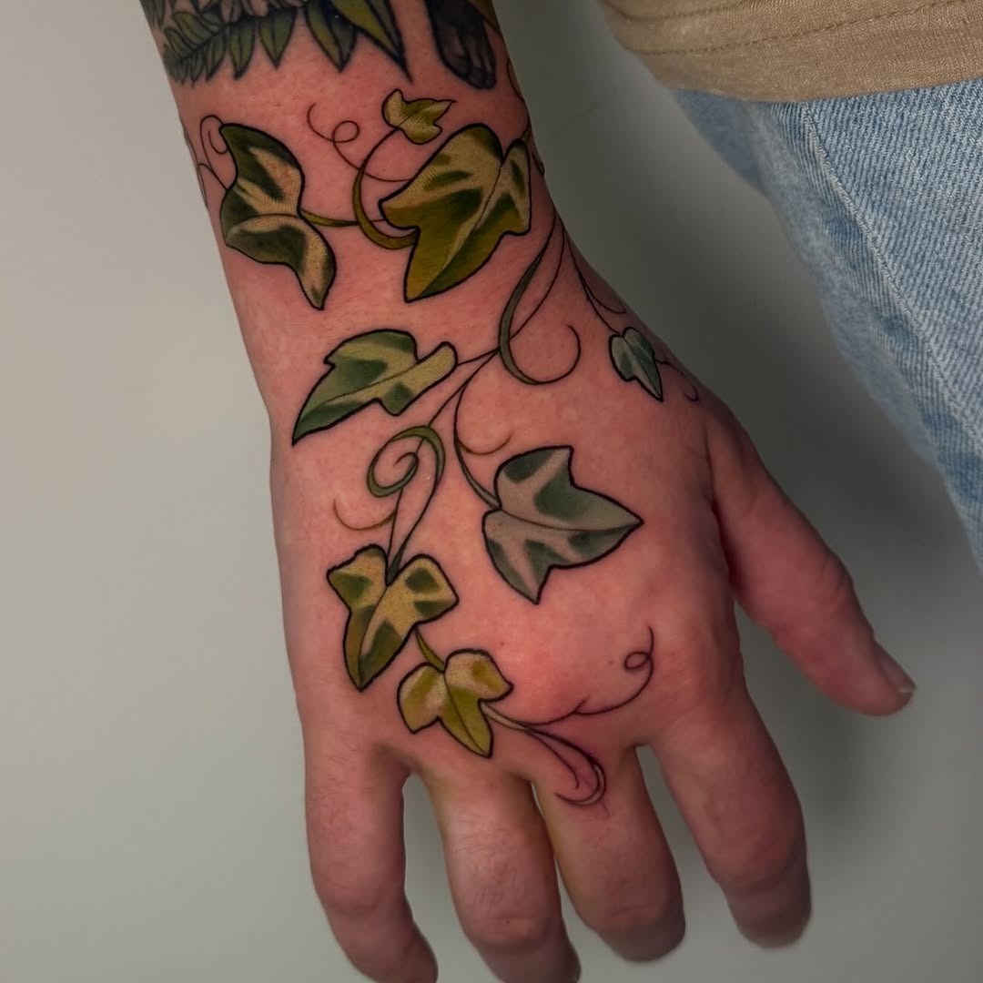 A Lively Ivy Tattoo Embellishing the Hand Tattoo Design