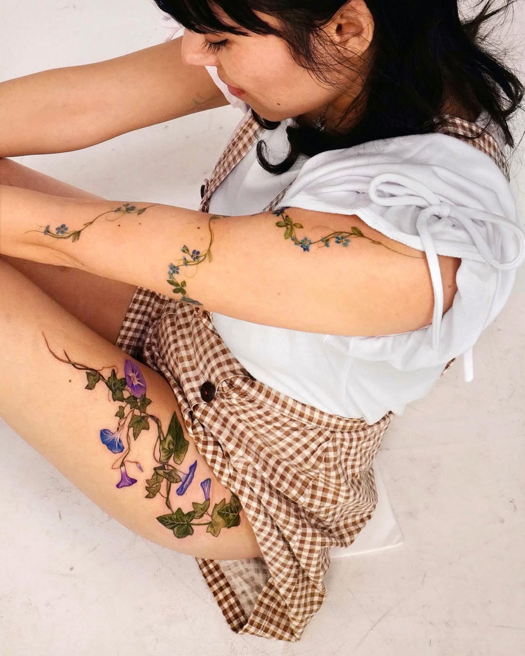 Colorful ivy tattoos on a woman’s arms Tattoo Design